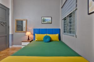 a bedroom with a bed with blue and yellow at Hanoi Sihouse Eco in Hanoi