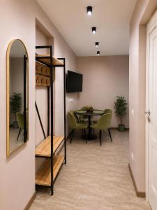 a dining room with a table and a mirror at SMART flat - Ranna 49 in Sillamäe