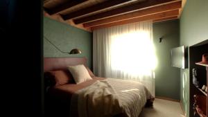 a bedroom with a bed and a large window at Burramys in Dinner Plain