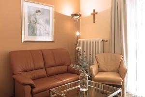 a living room with a couch and a chair and a table at Aparthotel Alter Weißbräu in Bad Birnbach