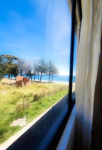 a view of the ocean from a train window at Lodge & Camping Suma Samawi in Copacabana +54 photos