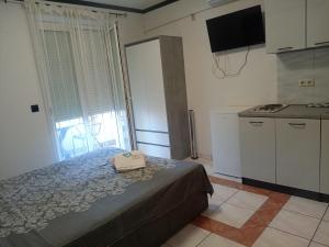 a small bedroom with a bed and a kitchen at Apartments Angie in Biograd na Moru