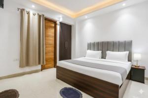 a bedroom with a large bed and a window at Hotel Royal Green - Green Park Metro in New Delhi