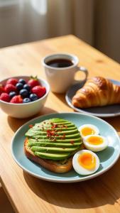 a plate with eggs avocado and toast on a table at Hotel Royal Green - Green Park Metro in New Delhi