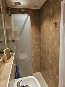 a bathroom with a sink and a shower at Blu Apartament in Strzelno +29 photos