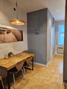 a dining room with wooden tables and chairs at Blu Apartament in Strzelno