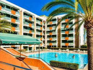 a swimming pool in front of a large apartment building at Solymar Premium Apartment in Playa del Ingles