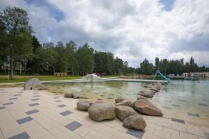 a swimming pool with a fountain in a park at Glamping Babákov in Včelákov