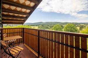 a balcony with a bench and a view of the mountains at Green Escape garni hotel in Postojna