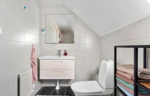 a white bathroom with a sink and a toilet at Villa in Skurup in Skurup +16 photos