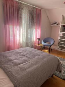 a bedroom with a bed and a chair and a window at Villa in Skurup in Skurup