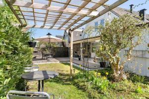 a patio with a table and an umbrella at Villa in Skurup in Skurup