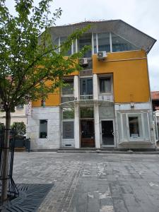 a yellow and white building on a city street at Studio Celjeapp in Celje
