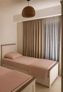 a bedroom with two beds and a window at Marassi- Faya Residence in El Alamein +8 photos