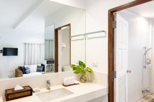 a bathroom with a sink and a mirror at Malibu Beach Resort Samui in Chaweng +100 photos