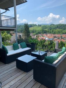 a patio with couches and tables on a deck at Chalet im Chiemgau in Siegsdorf