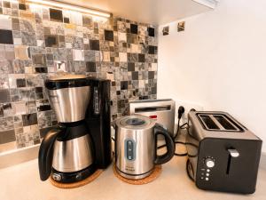 a kitchen counter with a coffee maker and a toaster at Solymar Premium Apartment in Playa del Ingles