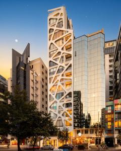 a tall building in a city with tall buildings at Harmony Coliving Ecuador Pool Carolina Park Quito in Quito