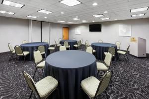 a conference room with tables and chairs and a podium at Wingate by Wyndham Little Rock in Little Rock +45 photos
