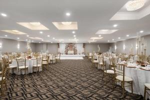 a banquet hall with tables and chairs in a room at Wyndham Garden Manassas in Manassas +45 photos