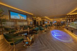 a bar with green chairs and tables in a restaurant at Tryp By Wyndham Istanbul Sancaktepe in Istanbul