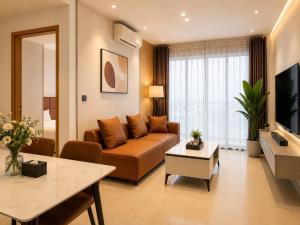 a living room with a couch and a table at Axis Residences Apartment in Phumĭ Prêk Chrey