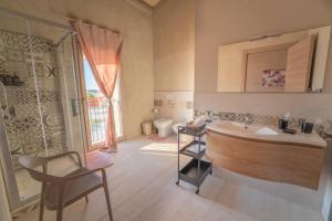 a bathroom with a sink and a toilet at U Minnulitu in Caltagirone +30 photos