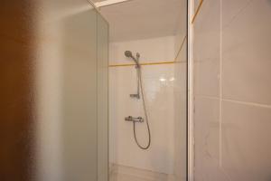 a shower with a glass door in a bathroom at Duplex Très Calme in Meria +15 photos