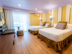 a hotel room with two beds and a chair at The Lodge Jamberoo in Jamberoo +81 photos