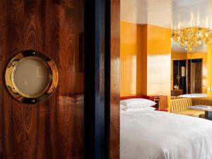 a bedroom with a bed and a mirror on a wall at The Manner, The Unbound Collection by Hyatt in New York +156 photos