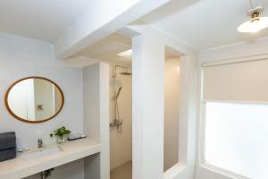 a bathroom with a sink and a mirror at Malibu Beach Resort Samui in Chaweng