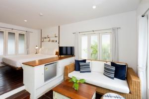 a bedroom with a bed and a couch and a bed at Malibu Beach Resort Samui in Chaweng