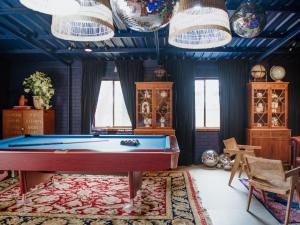 a pool table in a room with blue ceilings at The Lodge Jamberoo in Jamberoo