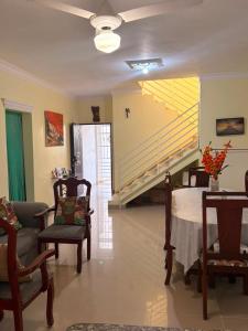 a living room with a table and chairs and a staircase at Casa brisa del caribe in Juan López +29 photos