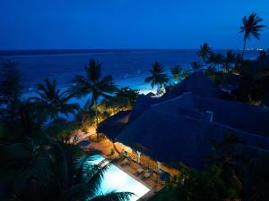 a view of a resort with a beach at night at Zoi Retreat Hotel Zanzibar in Matemwe +83 photos