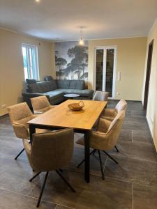 a living room with a wooden table and chairs at Flachsberg in Huf