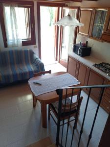 a small kitchen with a table and a couch at Corte Maria in Vicenza +10 photos