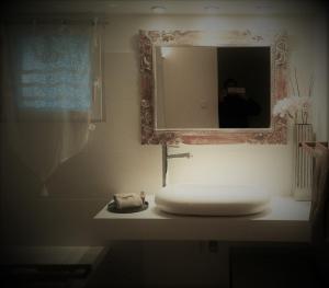 W łazience znajduje się biała umywalka i lustro. w obiekcie Lou Ventoulet w mieście Mouriès