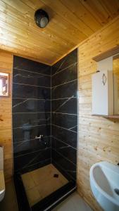 a bathroom with a shower and a sink at SkyGona Alpine Retreat in Ghebi +76 photos