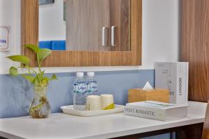 a kitchen counter with a bottle of water and a box at Hanoi Sihouse Eco in Hanoi