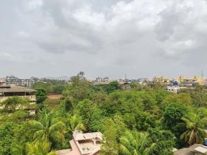 an aerial view of a city with trees and buildings at Lions Hotel Adidev in Badlapur