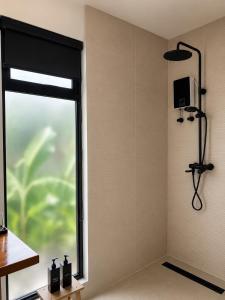 a bathroom with a shower with a window at CASA BUKO Tropical Homes El Nido in El Nido
