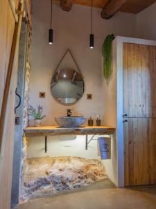 a bathroom with a sink and a mirror at Can Rata in Tivenys