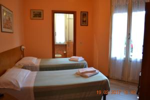 Postel nebo postele na pokoji v ubytování Albergo Cinzia