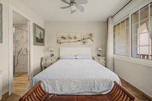a bedroom with a bed and a ceiling fan at Casa Del Sol in Calafell +24 photos