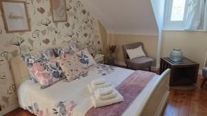 a bedroom with a bed and a chair at au fil de l'oust in Rohan