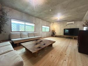 a living room with a couch and a coffee table at Deer Path Nara in Nara