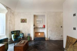 a living room with a couch and a coffee table at P43 Sicilian Suites in Ragusa