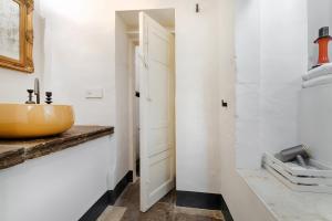 a bathroom with a yellow sink and a mirror at P43 Sicilian Suites in Ragusa +43 photos