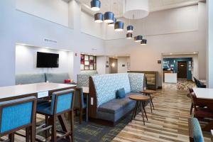 a waiting room with chairs and a couch and tables at Hampton Inn & Suites Salinas in Salinas